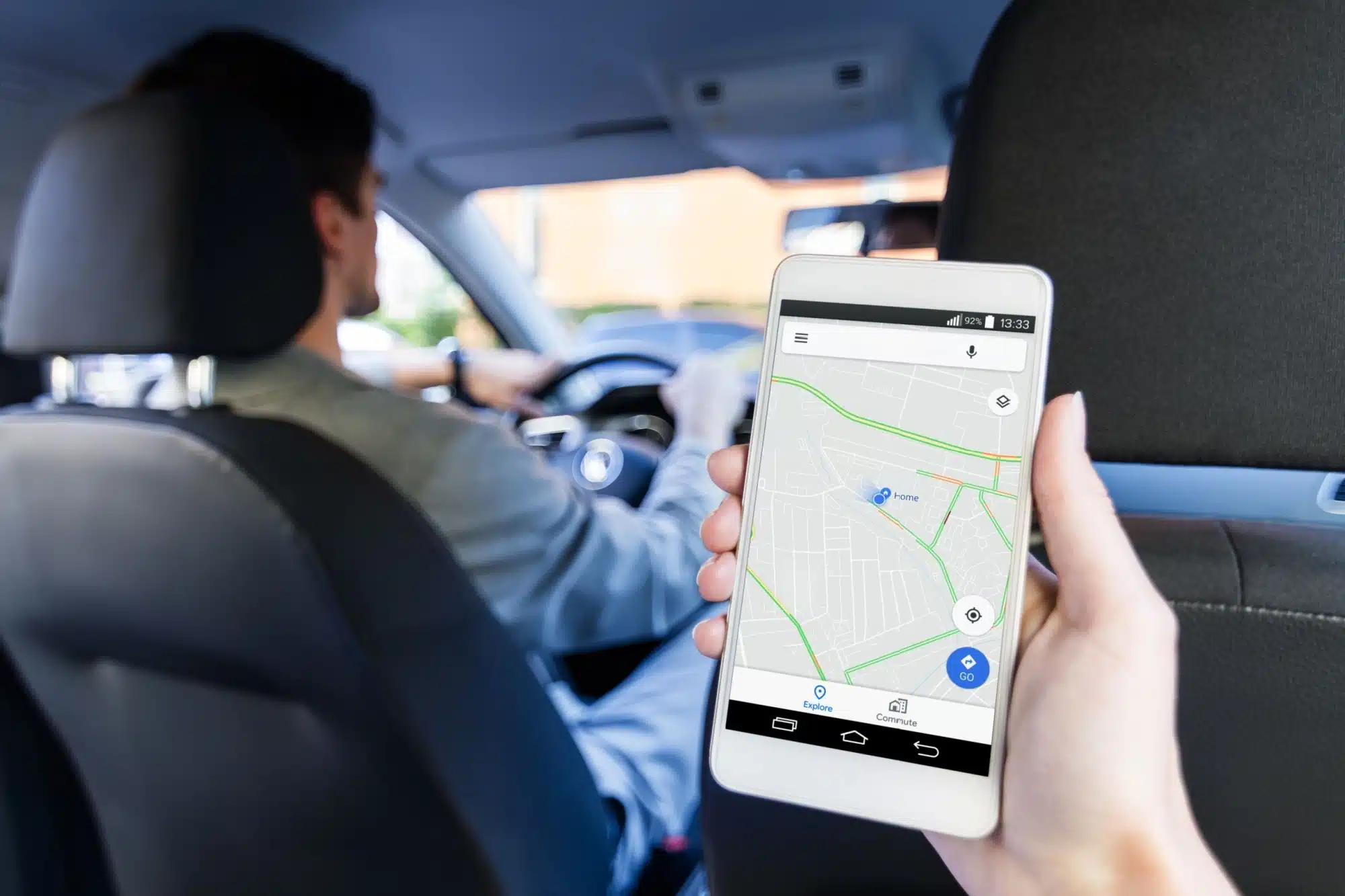 Backseat view of a rideshare driver and a map